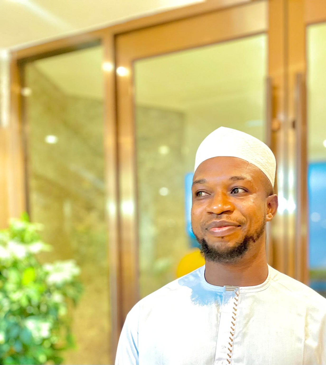 Idowu Tobi Aniyikaiye wearing white Nigerian traditional attire